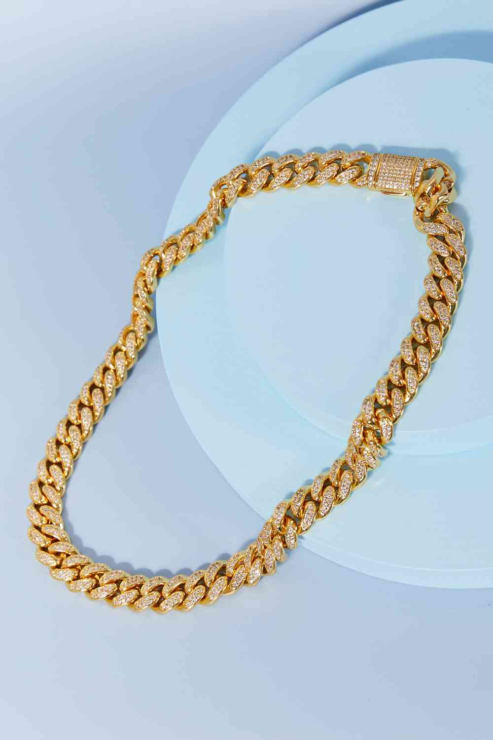 Brass curb chain necklace with cubic zirconia accent – 18-inch length, flat lay style.