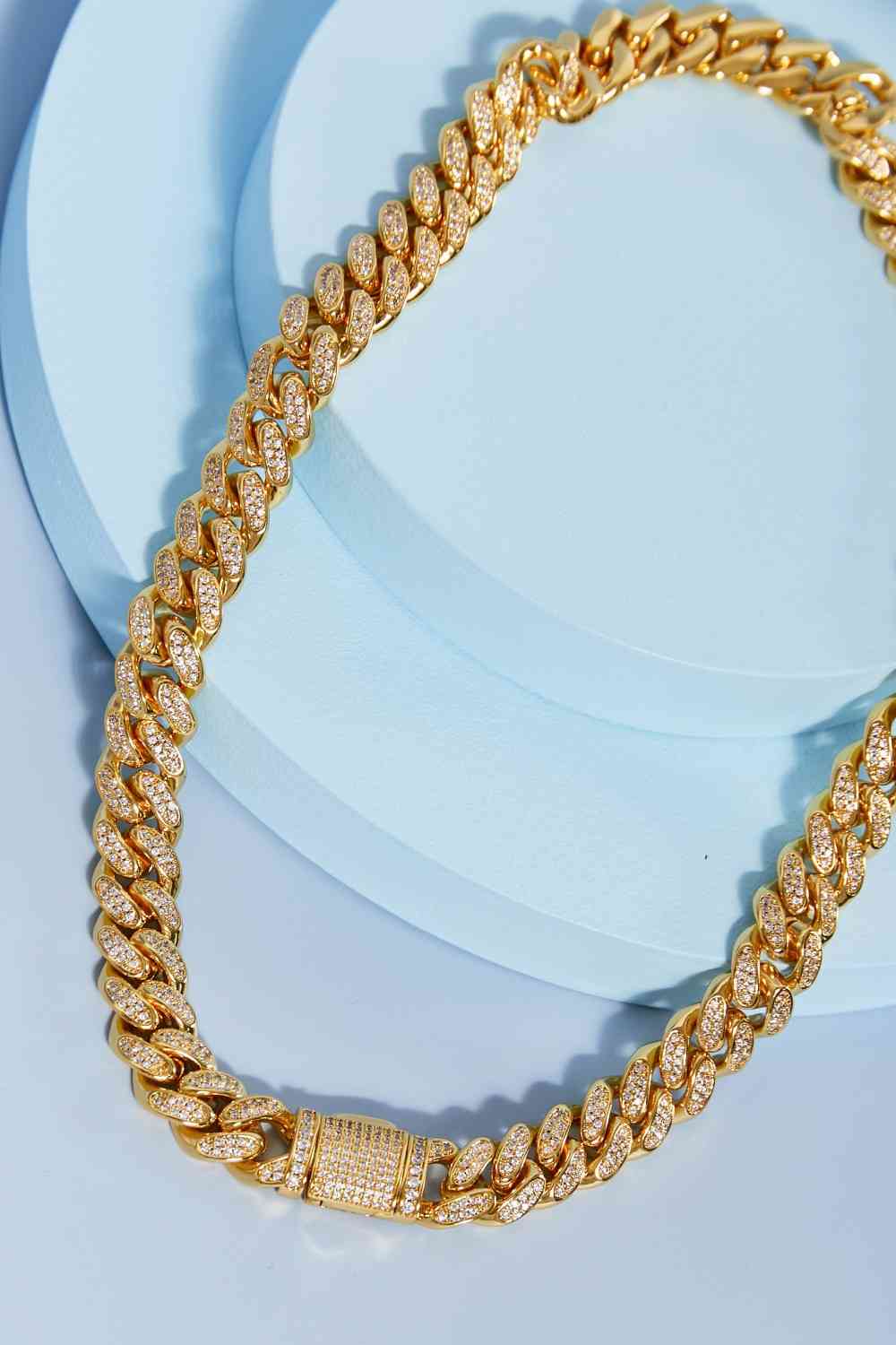 Brass curb chain necklace with cubic zirconia accent – 18-inch length, flat lay style.