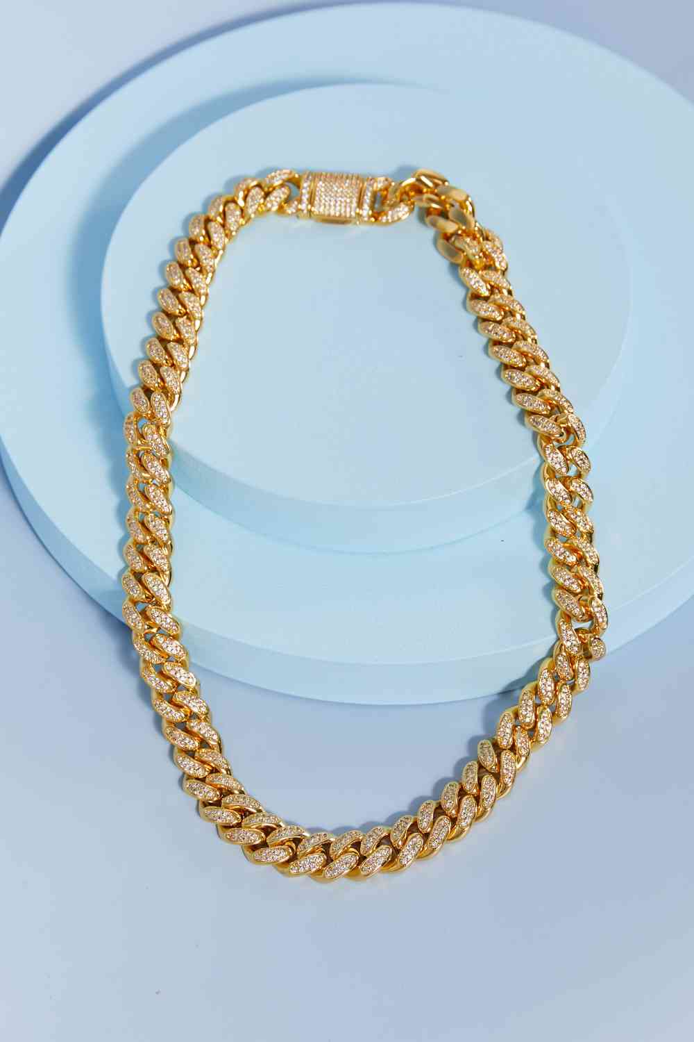 Brass curb chain necklace with cubic zirconia accent – 18-inch length, flat lay style.