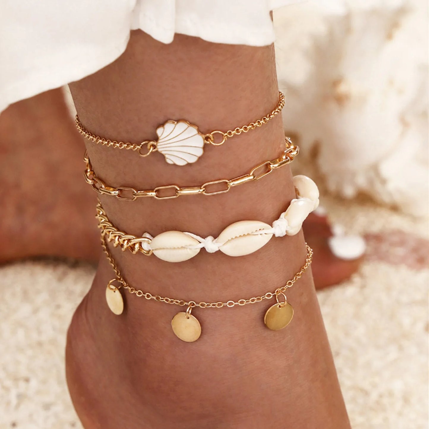 "Woman wearing boho beach anklet with shell design at the beach"