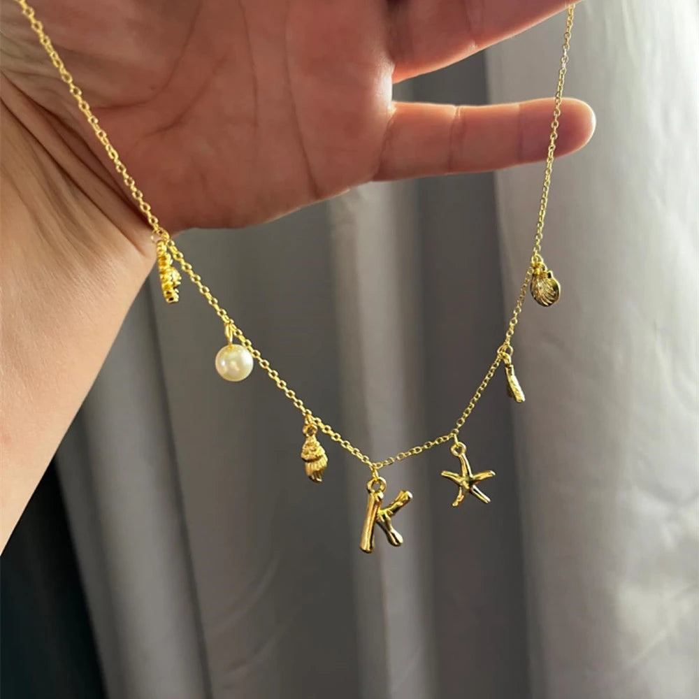 "Personalized Initial Surfer Girl Necklace with Starfish and Pearl Pendant"
"Bohemian Beach Necklace Gift for Women with Initial Pendant"
"Surfer Girl Initial Letter Necklace with Seashell and Starfish"
"Beach Jewelry for Women – Customizable Initial Necklace"