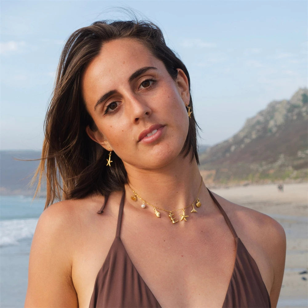 "Personalized Initial Surfer Girl Necklace with Starfish and Pearl Pendant"
"Bohemian Beach Necklace Gift for Women with Initial Pendant"
"Surfer Girl Initial Letter Necklace with Seashell and Starfish"
"Beach Jewelry for Women – Customizable Initial Necklace"