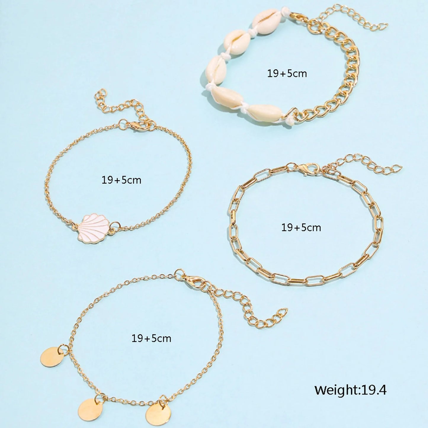 "Close-up of 4-piece anklet set featuring pearl and scallop charms"